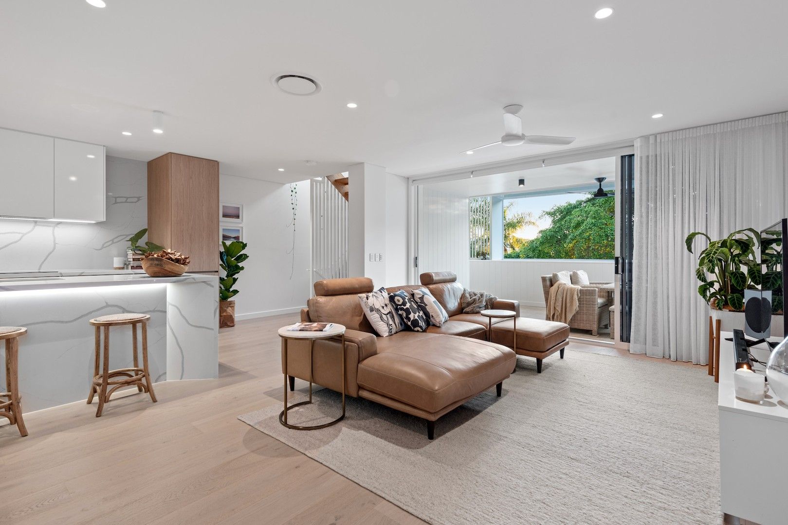 Warilda Street Terraces living room with large windows offering views of the surrounding green spaces