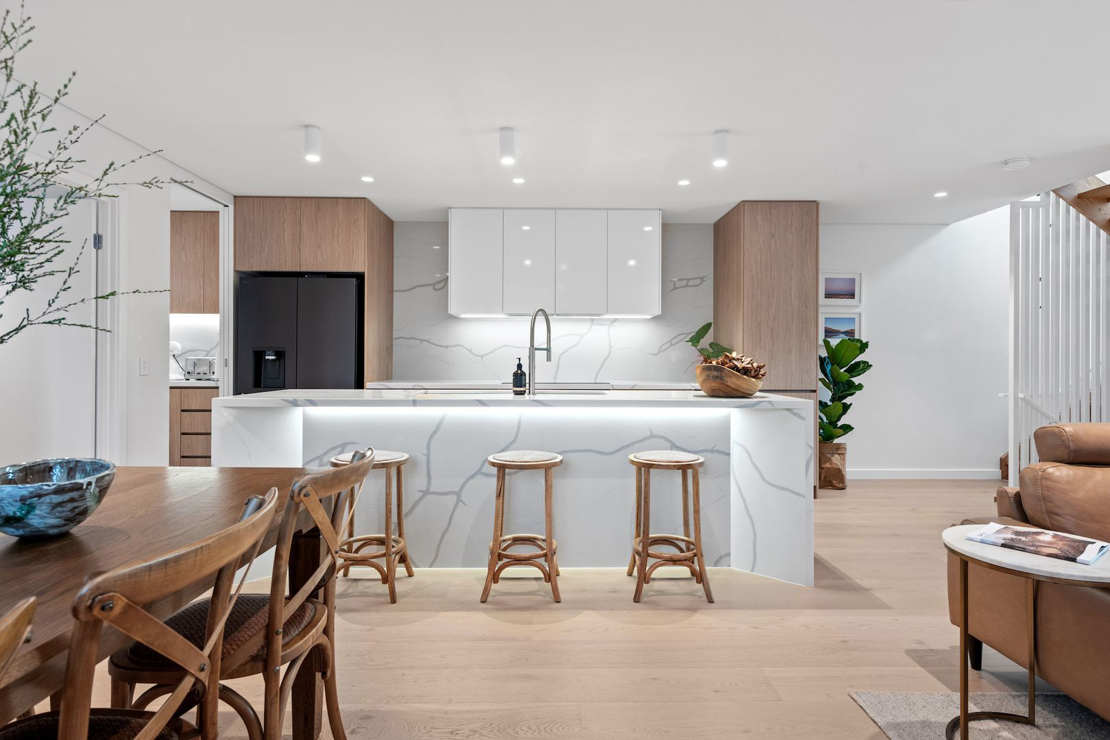 Modern kitchen design at Warilda Street Terraces featuring high-end appliances and natural wood finishes