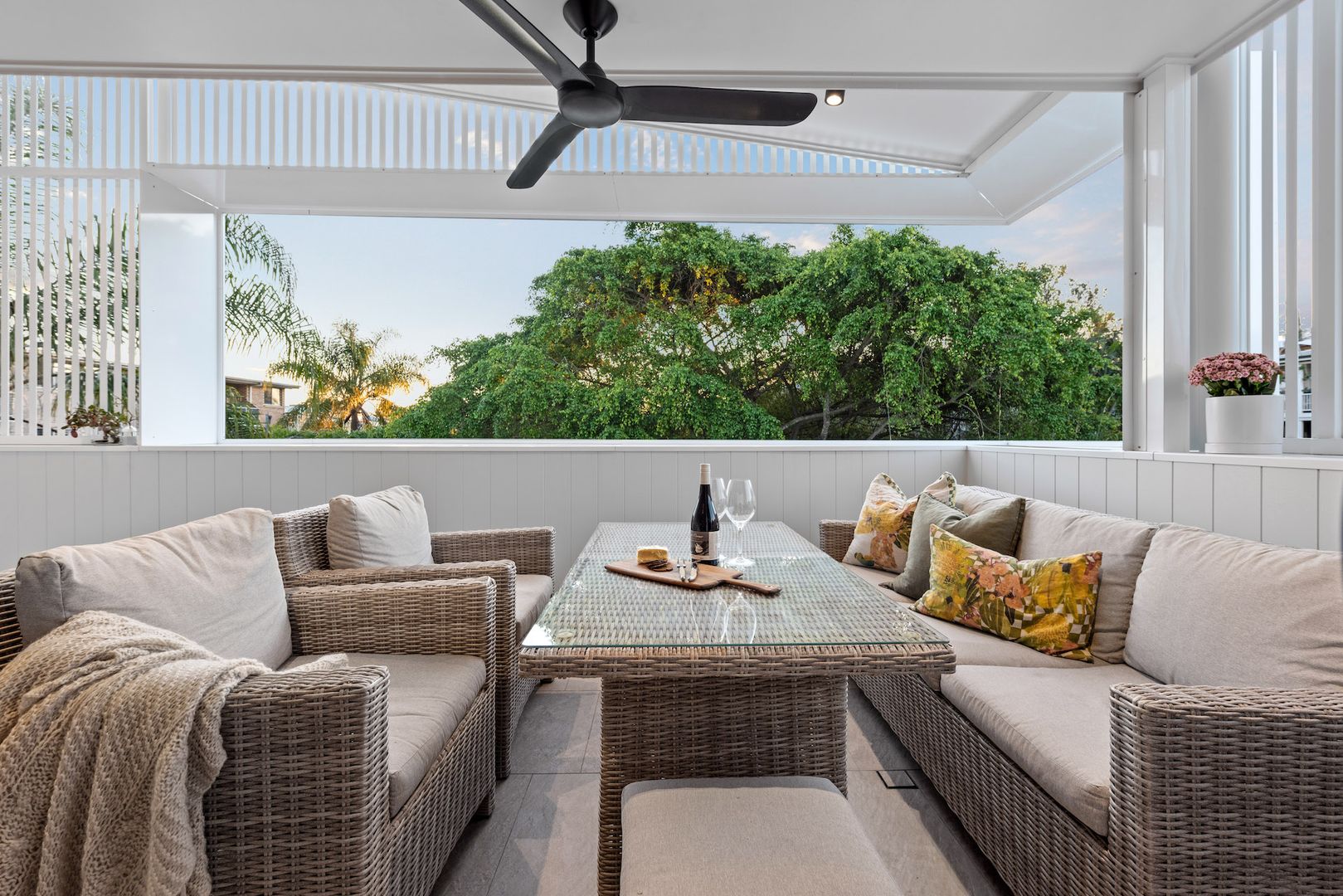 Warilda Street Terraces balcony with outdoor seating and lush green views