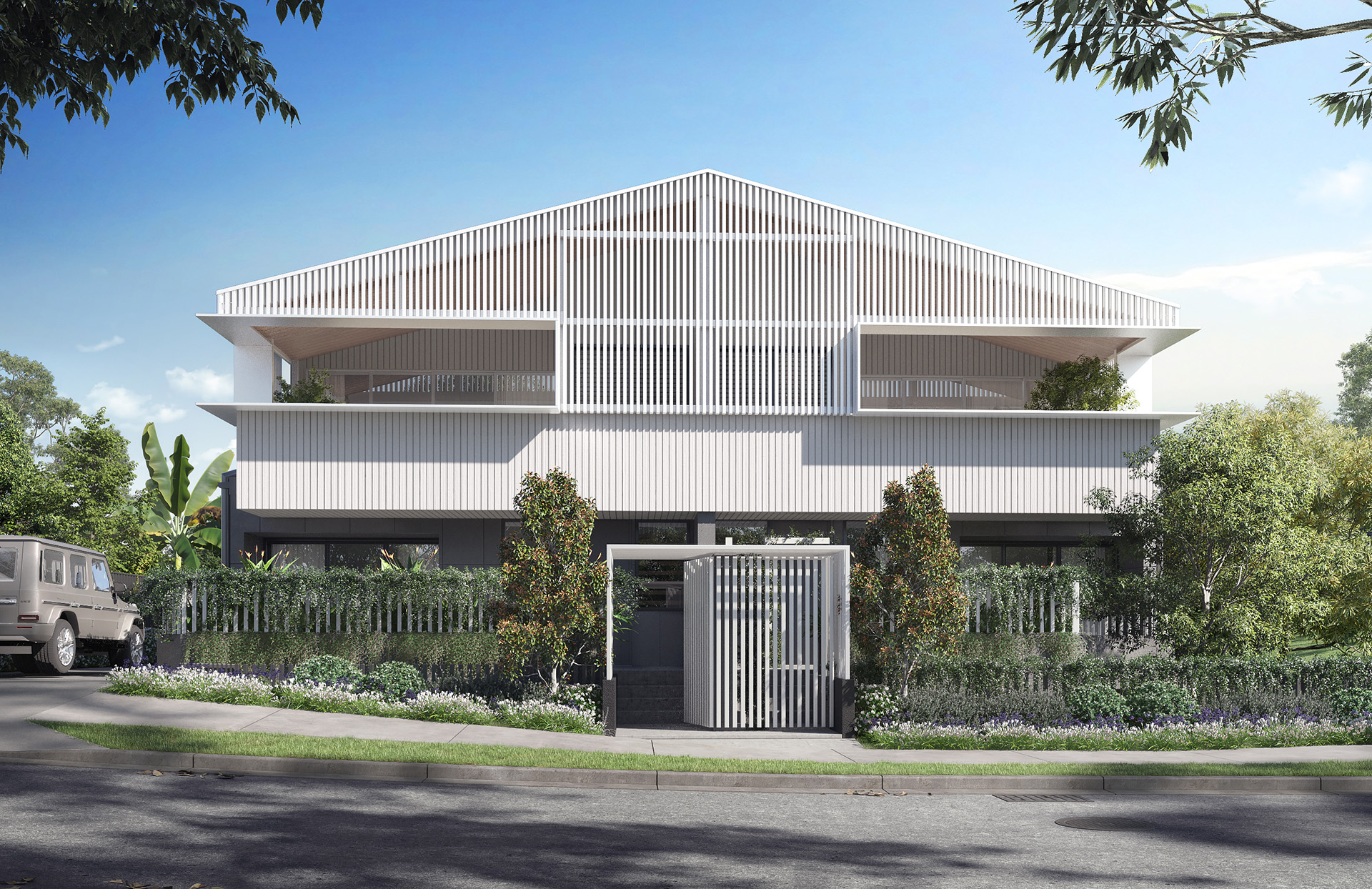 Exterior view of Warilda Street Terraces showcasing modern townhouses with green space in the background