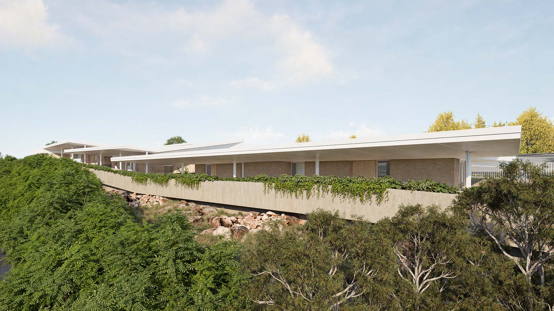 Elevated view of the exterior of the Canterbury College Early Learning Centre from the south-west highlighting the covered external circulation ramps.